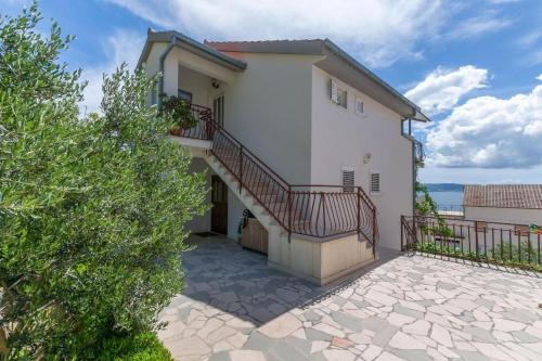 a large white house with a staircase on it at Villa Maria in Jesenice