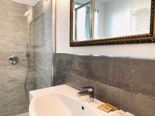 a bathroom with a sink and a mirror at Appartamenti Sant Andrea in Levanto