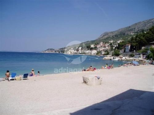 a group of people on a beach near the water at Villa Maria in Jesenice