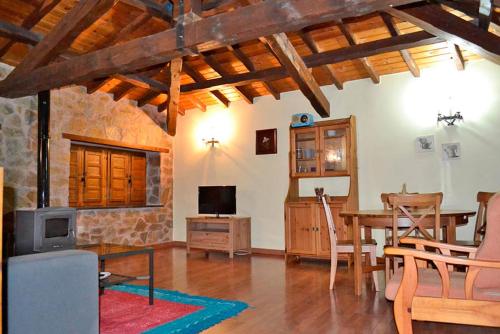 a living room with a table and a dining room at Pedrazales Rural in Pedrazales