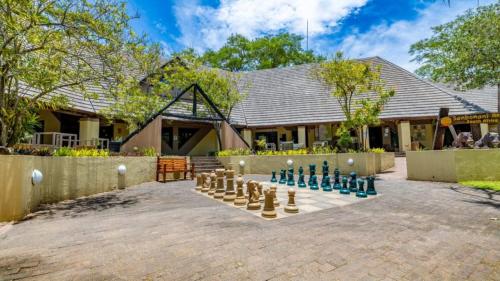 a game of chess on a brick patio at Sanbonani Hotel in Hazyview