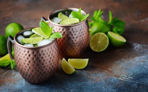 two cups filled with lime and mint on a table at Hotel Lerch in Sankt Johann im Pongau