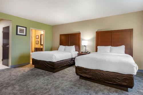 a hotel room with two beds and two lamps at Comfort Inn Bentonville - Crystal Bridges in Bentonville