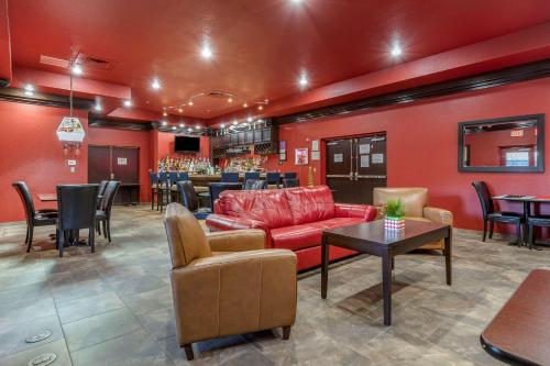 a lobby with a red couch and a bar at Comfort Inn Bentonville - Crystal Bridges in Bentonville
