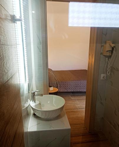 a bathroom with a bowl sink on a counter at Lord Complex in Agios Georgios