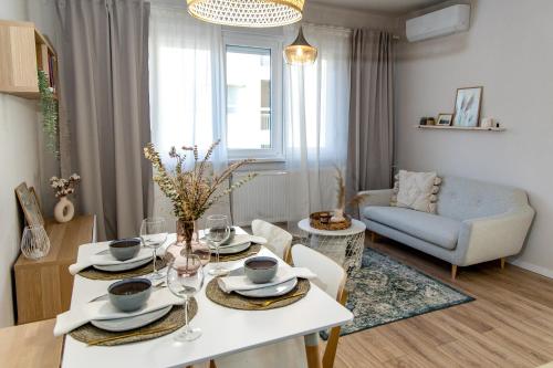 a living room with a table and a couch at Wanderer Center in Debrecen