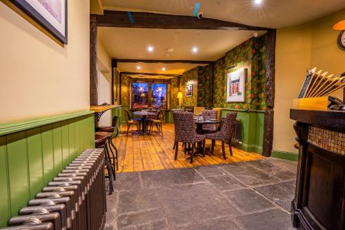 a bar with chairs and tables in a restaurant at The Crown Hotel in Glastonbury