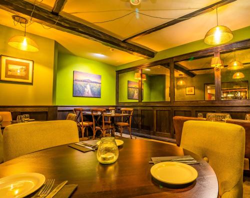 a dining room with a wooden table and chairs at The Crown Hotel in Glastonbury