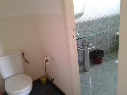 a bathroom with a toilet and a sink at B&B Au Triporteur in Antananarivo