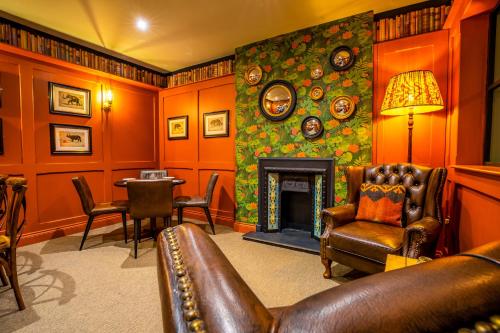 a living room with a couch and a fireplace at The Crown Hotel in Glastonbury