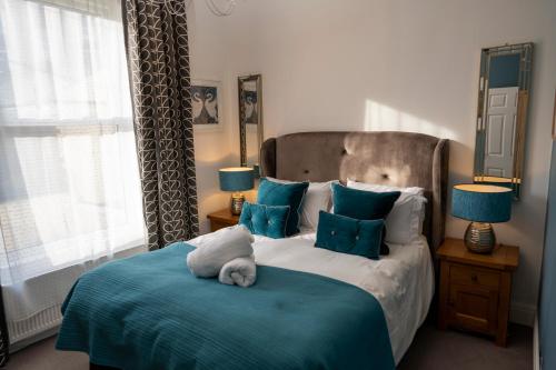 a bedroom with a bed with a stuffed animal on it at The Helaina Apartments in Scarborough