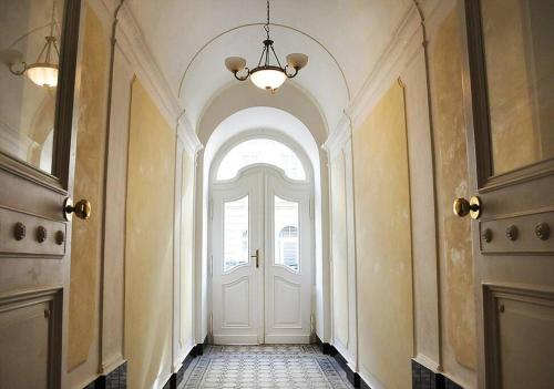 a hallway with a white door with a window at quiet apartment in a short distance from the city in Prague
