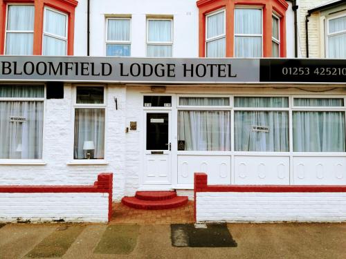 aldurned lodge hotel with two red benches in front at Bloomfield Lodge Hotel in Blackpool