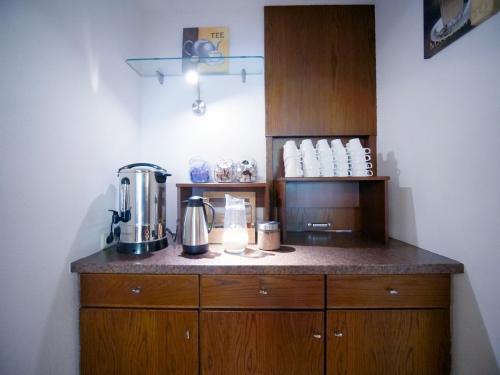 a kitchen with a counter with a coffee maker at Gästehaus Parkblick in Rust