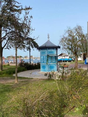 a blue building in the middle of a park at Seixal Old Town River View Apartment in Seixal