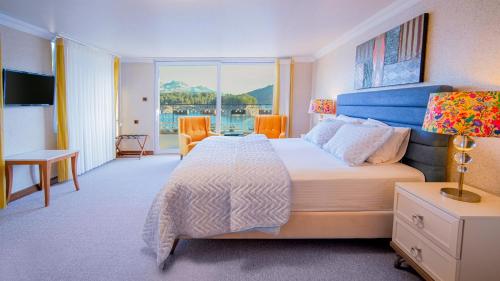 a bedroom with a large bed and a large window at Dolphin Boutique Hotel & Restaurant in Karacaören
