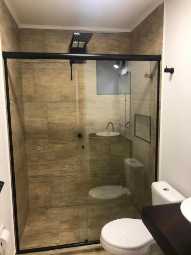 a bathroom with a shower with a toilet and a sink at Colonial Hostel in Sao Paulo