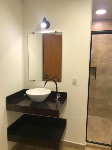 a bathroom with a sink and a mirror at Colonial Hostel in Sao Paulo