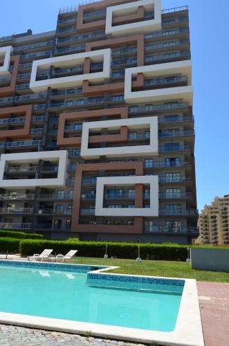 a building with a swimming pool in front of a building at ROCHA Tower 4D in Portimão