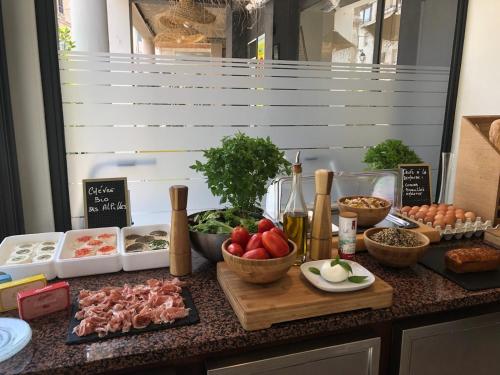 a counter topped with lots of different types of food at Maison Volver in Arles