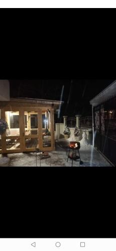 a fire pit in a backyard at night at Къща Томови,стаи за гости in Devin