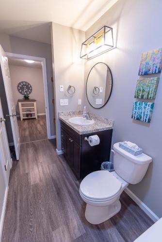 a bathroom with a toilet and a sink at Susitna Suites in Wasilla