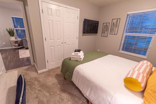 a bedroom with two beds and two windows at Susitna Suites in Wasilla
