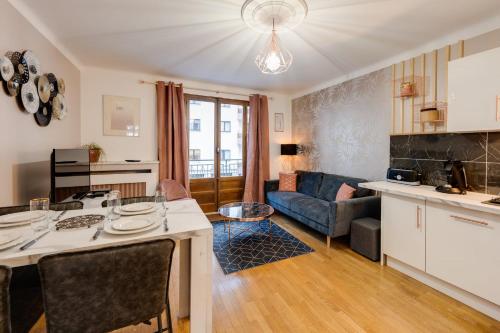 a kitchen and living room with a table and a couch at Les Mulots - Apartment T3 of 56 sqm in Annecy