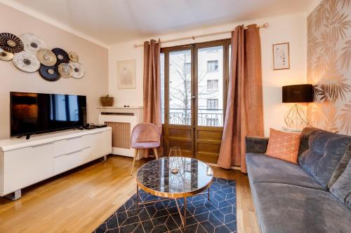 a living room with a couch and a tv at Les Mulots - Apartment T3 of 56 sqm in Annecy