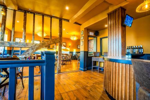 a restaurant with a bar and a dining area at The Crown Hotel in Glastonbury