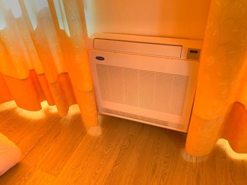 a air conditioner in a room next to a window at Apartamentos Sanjuan in Porriño