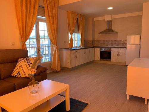 a living room with a couch and a table at Apartamentos Sanjuan in Porriño