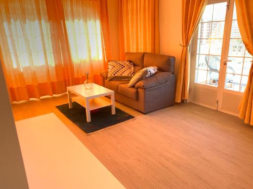 a living room with a couch and a table at Apartamentos Sanjuan in Porriño