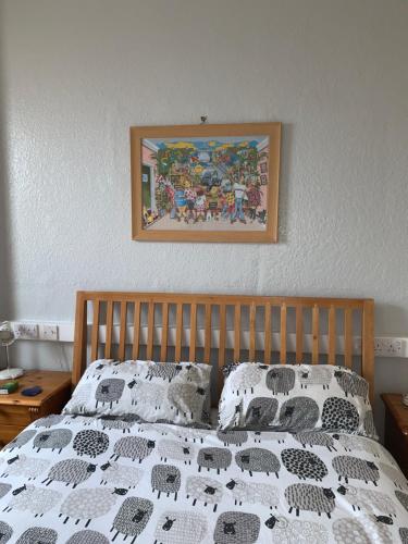 a bed with a black and white comforter and pillows at Brafferton Guest House in Hartlepool