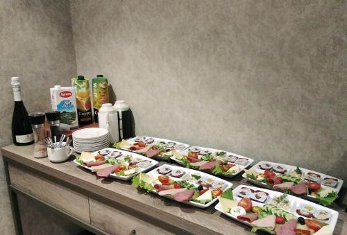 a buffet with several plates of sushi and bottles of wine at Castle Franco Suites in Istanbul