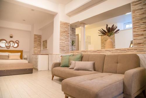 a living room with a couch and a bed at Mediterranean in Preveza