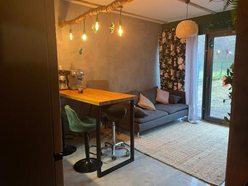 a living room with a table and a couch at Domek z Jacuzzi in Mrzeżyno