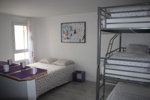 a bedroom with a bunk bed next to a desk at Magicappart in Magny-le-Hongre