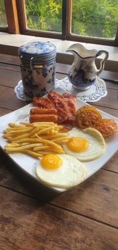 a plate of eggs and vegetables on a table at Van Dykshuis Guest House in Heidelberg