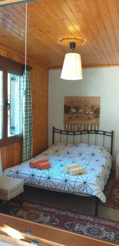 a bedroom with a bed in a room with a ceiling at Arachova Houses-Malvina in Arachova