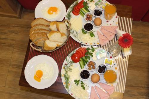 a table topped with plates of eggs and bread at Taksim Cihangir Fidan Residence Hotel in Istanbul