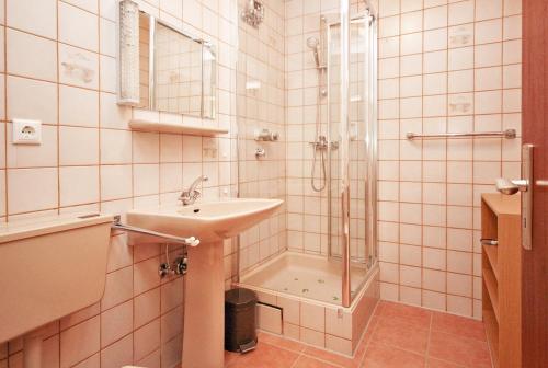 uma casa de banho com um lavatório e um chuveiro em Wiesenblick em Oy-Mittelberg