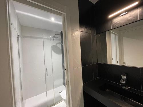 a bathroom with a shower and a sink and a mirror at Loft Ciudad Jardín in Córdoba
