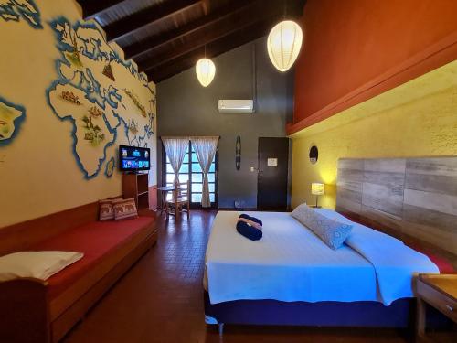 a bedroom with a large bed and a world map on the wall at Nomada Hostel in Asuncion