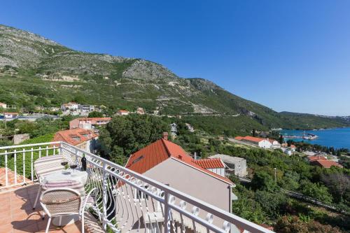 a balcony with a view of a town and the water at Villa Dubravka in Mlini