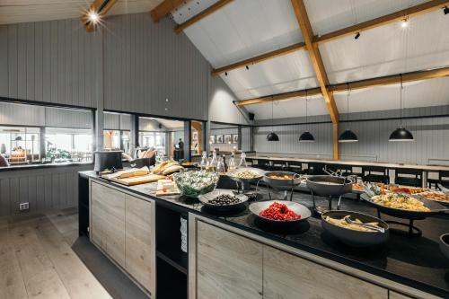 a kitchen with many bowls of food on a counter at Hotel Katla by Keahotels in Vík