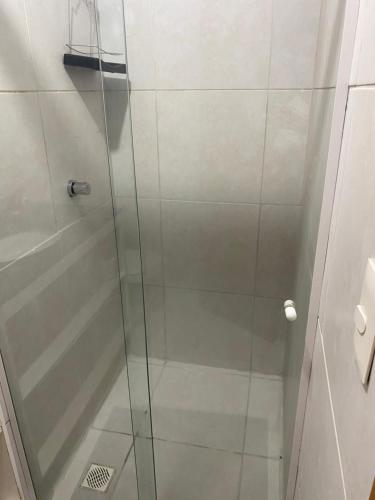 a shower with a glass door in a bathroom at Apartamento 2 quartos West Flat in Mossoró