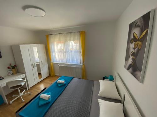 een kleine woonkamer met een blauwe tafel en stoelen bij Apartman Sweet Garden K&A in Zagreb