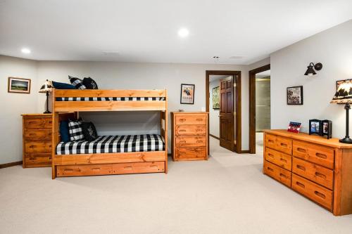 a bedroom with a wooden bunk bed and wooden dressers at 44 Aspen Meadow Drive in Edwards