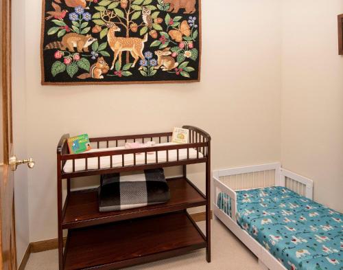 a baby room with a crib and a painting on the wall at 44 Aspen Meadow Drive in Edwards